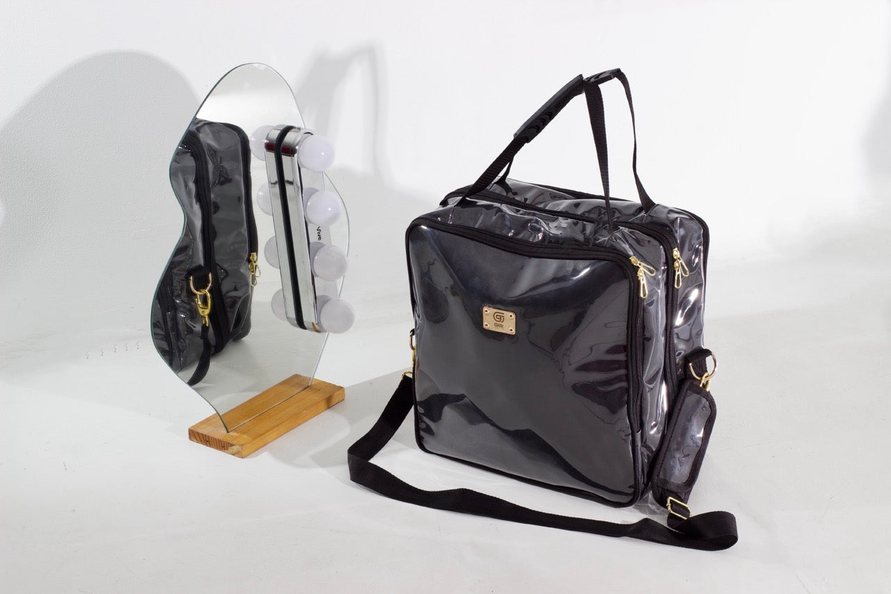 Hair Stylist bag, front faced, with a small mirror on the side showing a reflection of the side of the bag